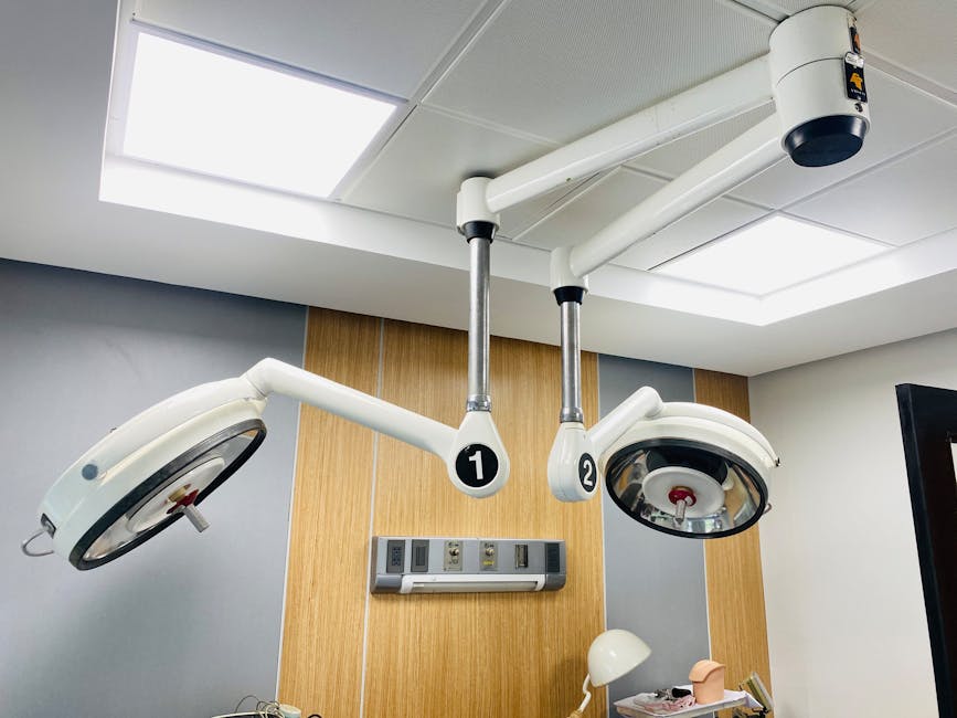Ceiling-mounted surgical lamps in a modern hospital setting, providing essential lighting.