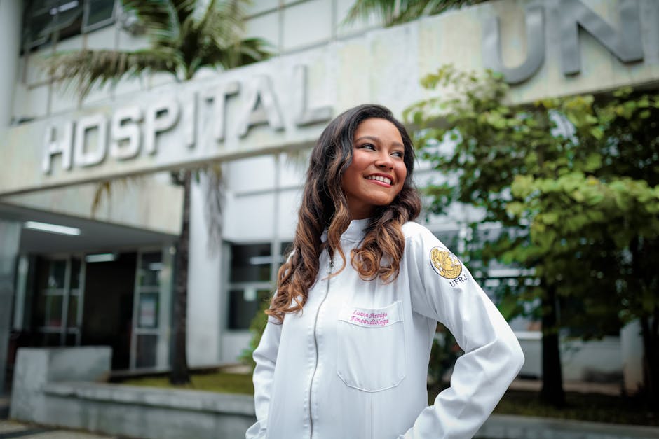 Smiling female doctor standing confidently outside a hospital building